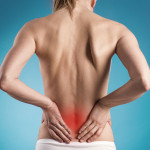 Muscle cramp or backache on naked woman’s back